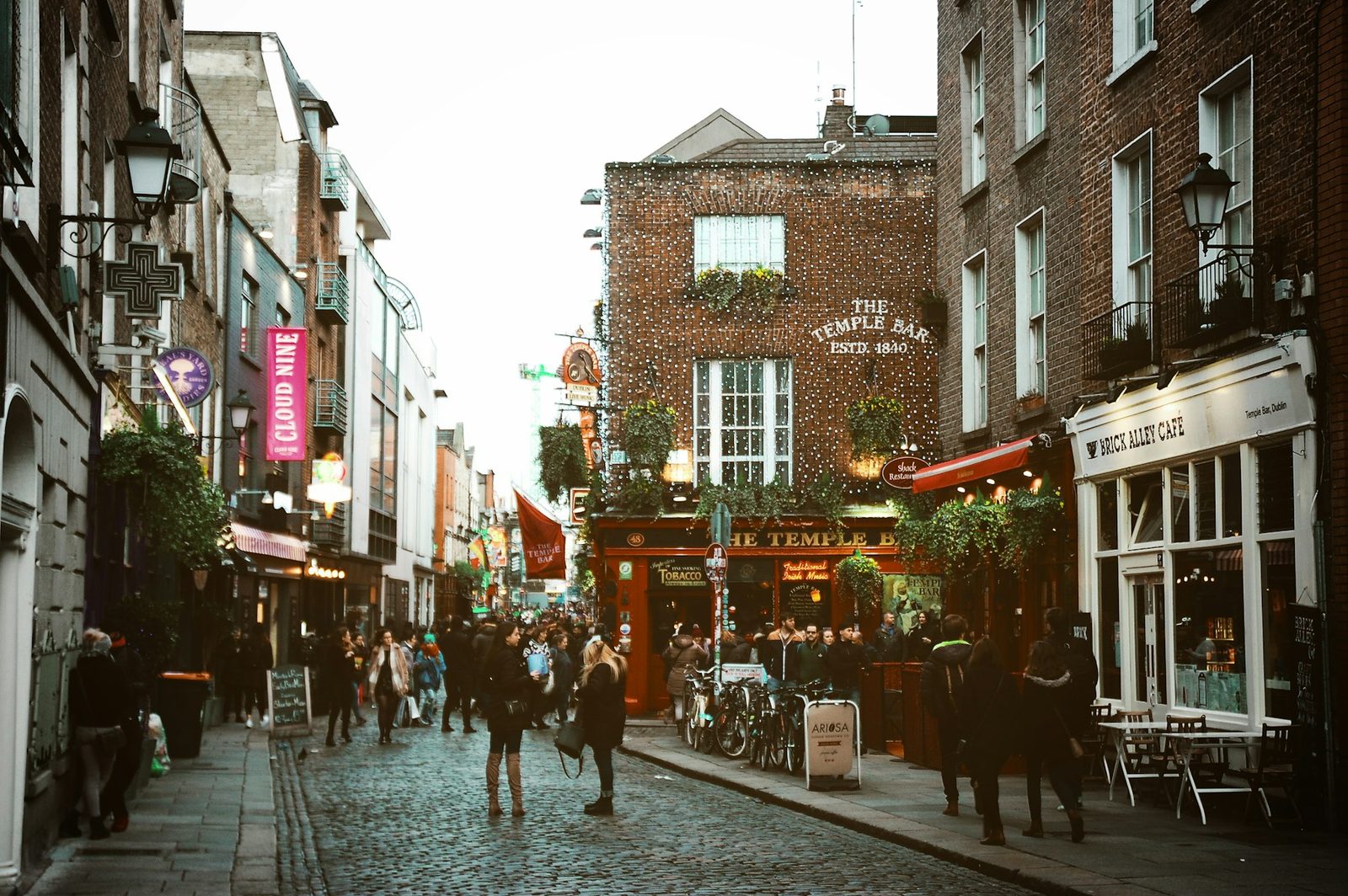 Painted pub fronts along a cobbled street in the Temple Bar quarter of Dublin, Ireland.